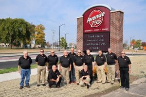 Avenue 795 board members in front of the new sign.