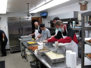 Knights of Columbus preparing food at the 10th annual chicken dinner.